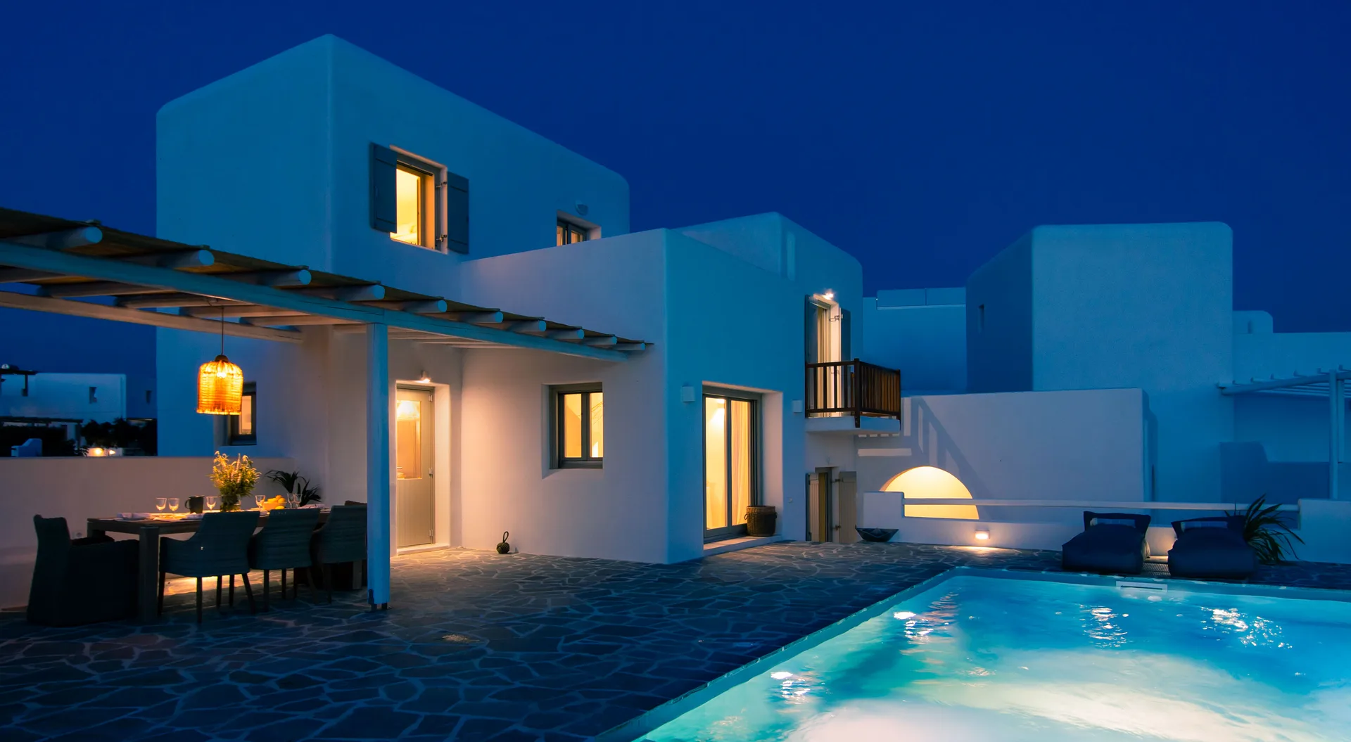 Ili at dusk, the pool lit against the evening